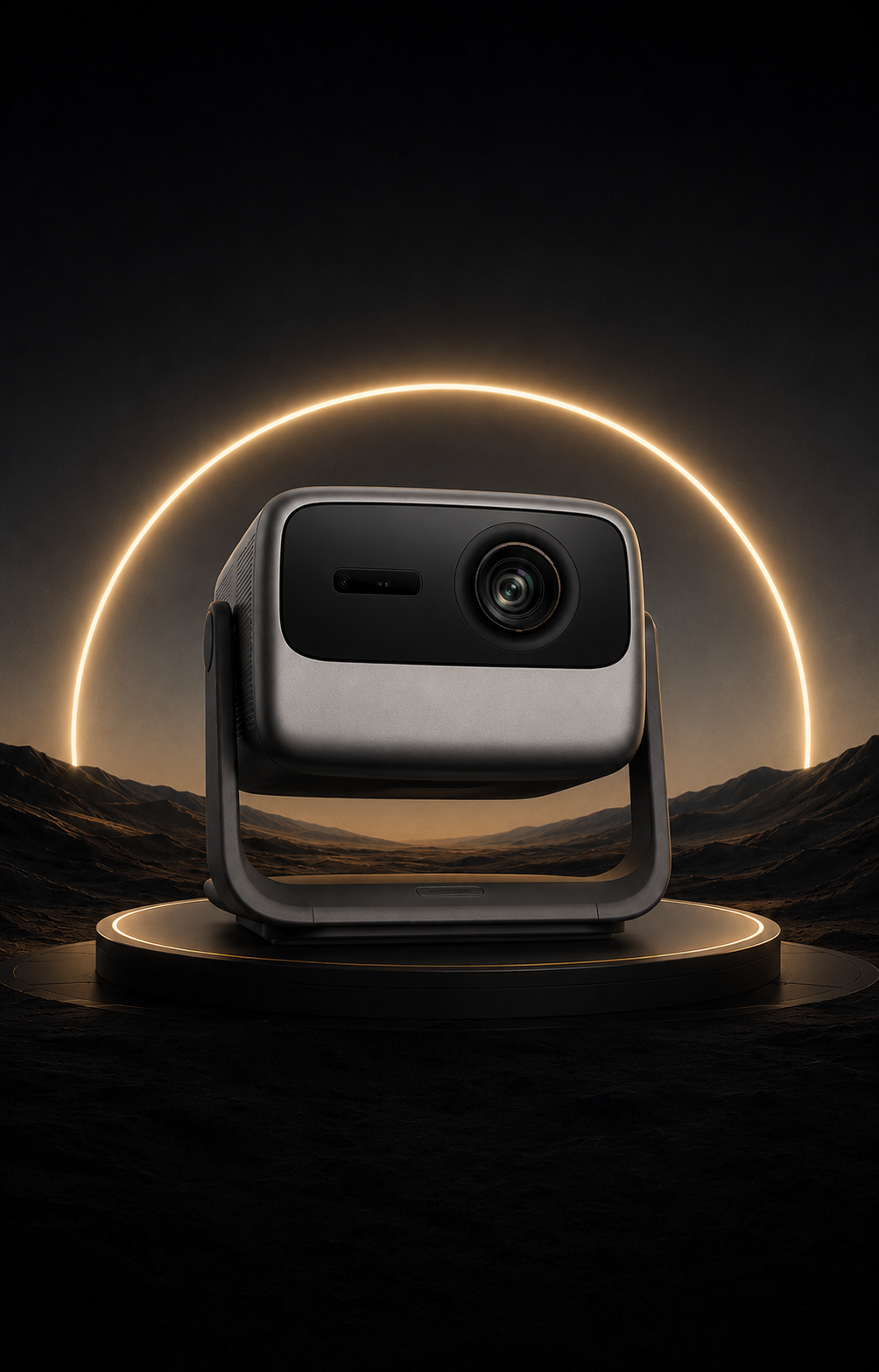 A modern projector or camera device with a matte black front and silver-gray body, displayed on a circular pedestal against a dark landscape with a glowing golden ring in the background.